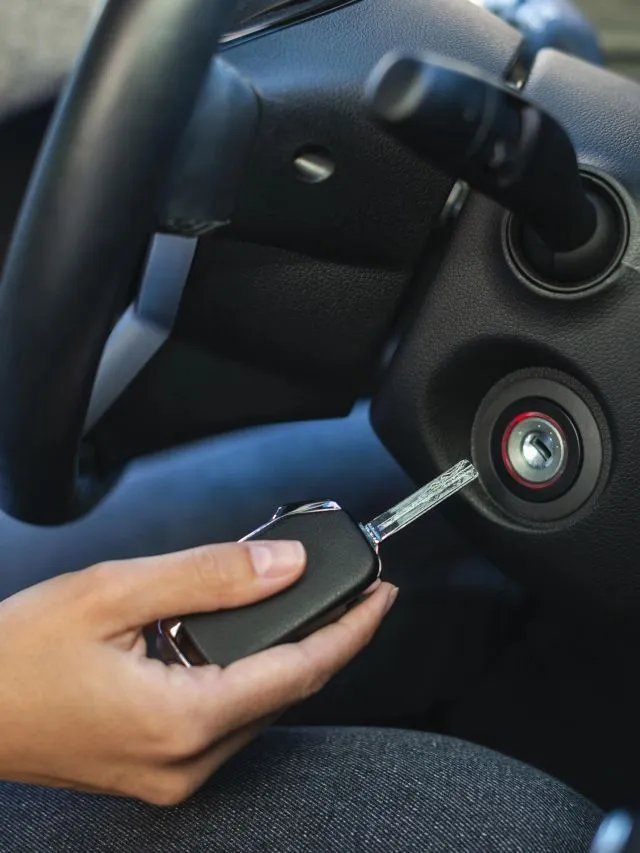 Professional locksmith unlocking car door with specialized tools